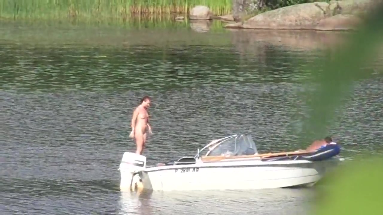 Nudist couple has fun in the middle of a beautiful lake voyeurstyle