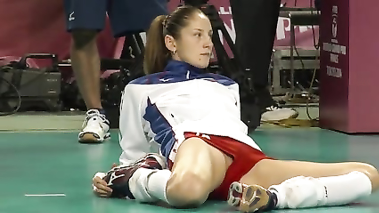 Volleyball girl in skintight shorts stretches before match voyeurstyle