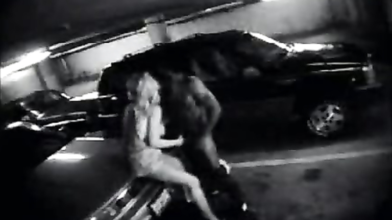 Parking garage sex on security camera with a charming blonde voyeurstyle photo